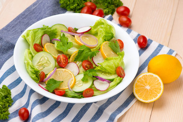 Homemade fresh green vegetable salad on table.