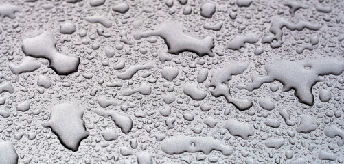 Raindrops on car surface. Selective focus