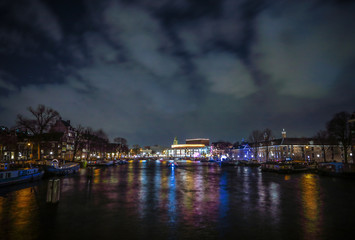 Obraz premium AMSTERDAM, NETHERLANDS - JANUARY 12, 2017: Beautiful night city canals of Amsterdam. January 12, 2017 in Amsterdam - Netherland.