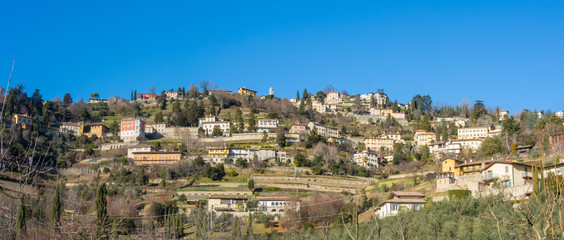 Fototapeta na wymiar View of the hills that surround Bergamo during a day with clear blue sky, Orobie area, Lombardy, Italy