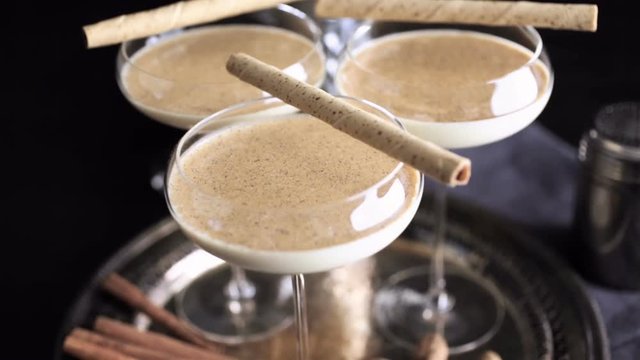 Egg nog cocktail in tall glasses on the tray at the minibar