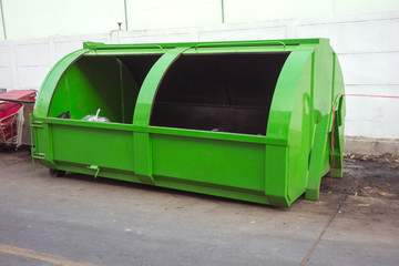 green large metal recycling dumpster, Rusty old dumpster behind