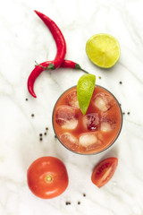 Bloody Mary cocktail, shot from above on white marble