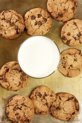 Chocolate chips cookies on tray with glass of milk