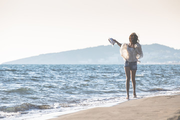 Young female enjoying sunny day on tropical beach