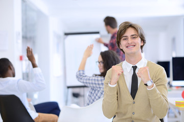 business, startup and people concept - happy creative team talking in office