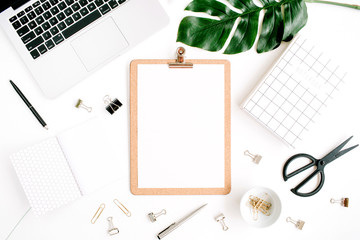 Home office workspace mockup with laptop, clipboard, palm leaf, notebook and accessories. Flat lay,...