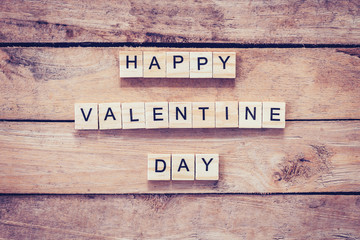 Wooden text for Happy Valentine Day on wood table background.