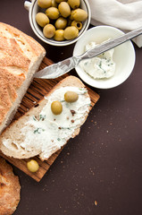 Homemade bread with cream cheese and olives