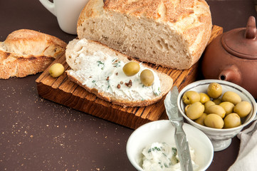 Homemade bread with cream cheese and olives