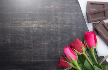 Valentine's day background with chocolate rose flower on wooden,