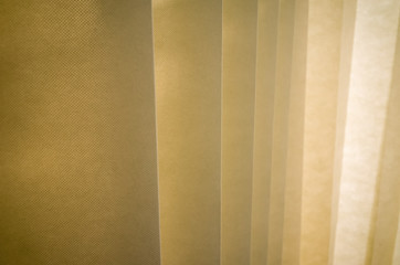 Obraz premium Hanging dividing curtain in a hospital ward. Folding room divider. Privacy curtain with multiple folds. Medical curtain hanging from a railing in a hospital room.