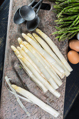 Spring season - fresh white and green uncooked asparagus, eggs,