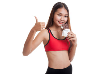 Beautiful healthy Asian girl thumbs up with chocolate.