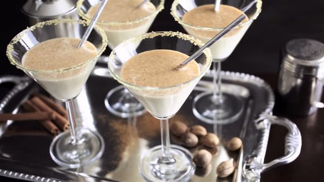 Egg nog cocktail in glasses rimmed with brown sugar at the minibar
