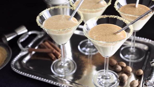 Egg nog cocktail in glasses rimmed with brown sugar at the minibar