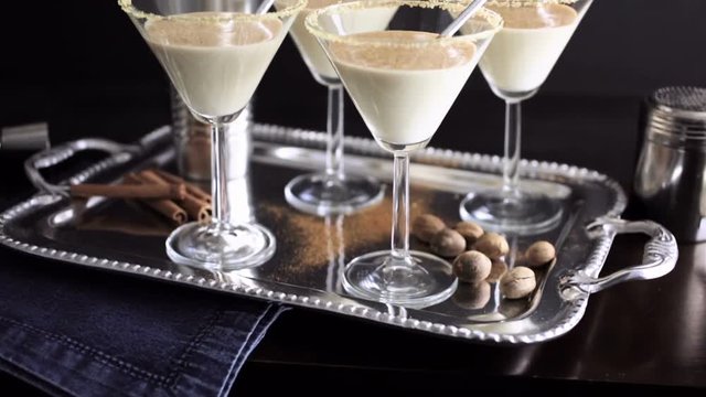 Egg nog cocktail in glasses rimmed with brown sugar at the minibar