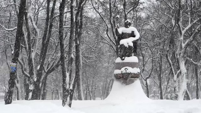 Winter. It is snowing. View of the Cathedral Square in Poltava in Ukraine. On the square are a monument to the outstanding Ukrainian Hetman Ivan Mazepa.