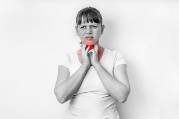 Woman with throat sore is holding her aching throat
