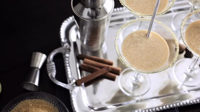 Egg nog cocktail in glasses rimmed with brown sugar at the minibar