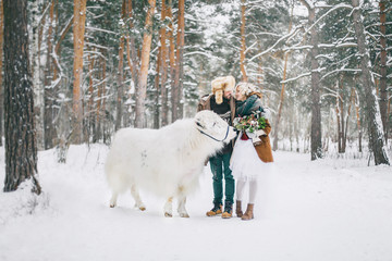 Fototapeta na wymiar Fairy-tale forest. A guy and a girl in the woods with Yak.