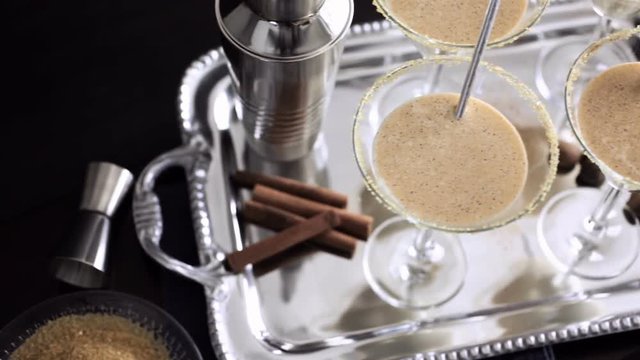 Egg nog cocktail in glasses rimmed with brown sugar at the minibar