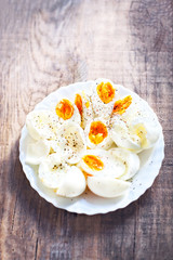 Hard boiled eggs, sliced in halves with black pepper spice on wh