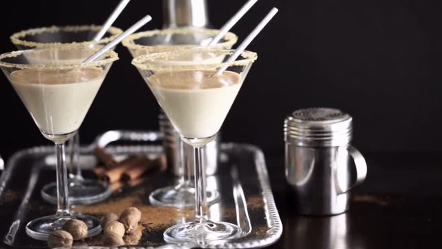 Egg nog cocktail in glasses rimmed with brown sugar at the minibar