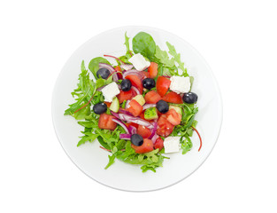Greek salad in a white dish on a light background
