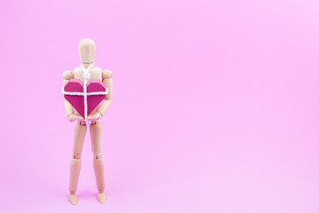 Wooden dummy chaining themselves to the paper box red heart shap