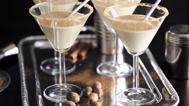 Egg nog cocktail in glasses rimmed with brown sugar at the minibar