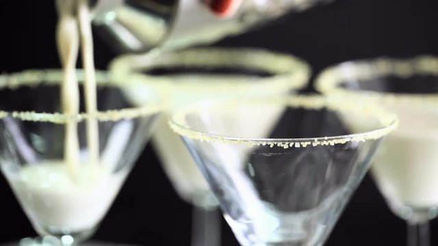 Time-lapse. Egg nog cocktail in glasses rimmed with brown sugar at the minibar