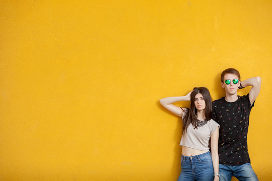 Young Cool Looking Man And Woman Posing In Fashion Style