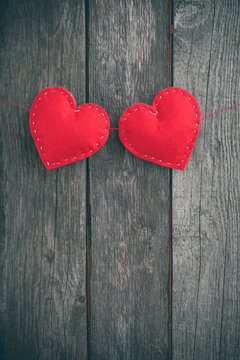 Valentine's day card. Red felt heart placed on vintage wood background and space for your text.