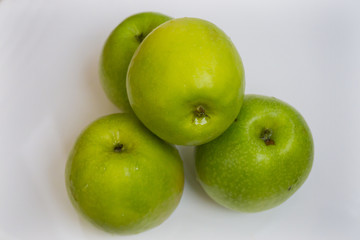 Fresh green apple fruits on white background