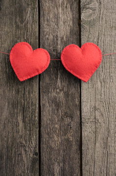 Valentine's day card. Red felt heart placed on vintage wood background and space for your text.