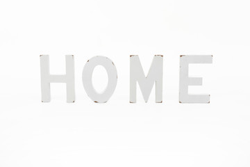 Decorative letters forming word HOME on white background. Rustic interior decor