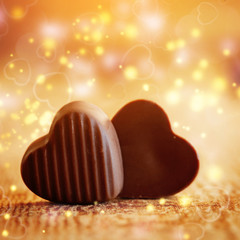 Two sweet chocolates hearts on a wooden background. Valentines day concept