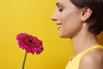 Profile view of woman holding flower