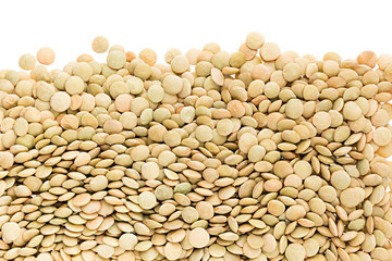 Border of green lentil closeup with copy space on white background. Isolated. Healthy protein food.