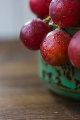 Close view of grapes in ceramic bowl.