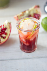 Fresh pomegranate drink - lemonade or cocktail with lime and ice
