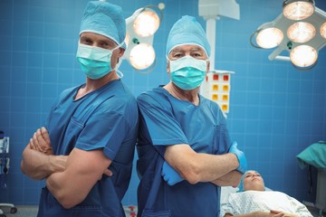 Portrait of male surgeons standing in operation theater