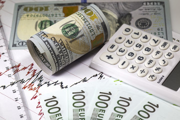 Fototapeta premium Dollar euro currency exchange prices chart. Red and black lines on the diagram. Ruler on the graph. Rolled hundred us dollar near calculator. Concept of currency trading.Macro image 