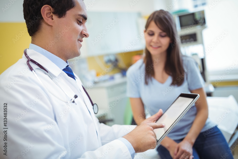 Aufkleber doctor using digital tablet while consulting patient