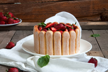 Strawberry Basil Tiramisu with fresh berries on a wooden background. No-bake cake.
