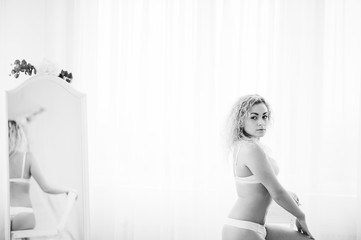 Curly blonde girl in underwear background mirror indoor white ro