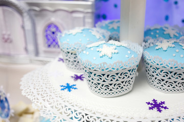 Cakes of blue color with snowflakes issued in winter style. Selective focus