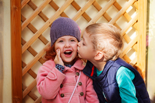 Little boy kissed for the first time adorable little girl. Love and romantic concept