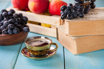 coffee in a cup, grapes and apples on a table, selective focus, copy space